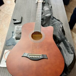Basic brown acoustic guitar with accesories